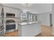 Bright kitchen with white cabinets, granite countertops, stainless appliances, and island for extra workspace at 3797 Churchill Sw Dr, Marietta, GA 30064