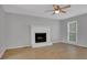 Bright living room featuring a classic fireplace, ceiling fan, and large window with plenty of natural light at 3797 Churchill Sw Dr, Marietta, GA 30064