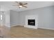 Spacious living room with wood flooring, featuring a charming fireplace and a seamless flow to adjacent rooms at 3797 Churchill Sw Dr, Marietta, GA 30064