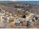 Panoramic aerial view of a suburban neighborhood, showcasing the layout and the natural surroundings with trees and roads at 6448 Mobilis Ct, Sugar Hill, GA 30518