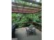 Cozy deck with a wood pergola, an outdoor dining set, and beautiful views of the backyard at 6448 Mobilis Ct, Sugar Hill, GA 30518