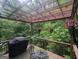 Relaxing deck with an outdoor dining set, beautiful views, and a grill at 6448 Mobilis Ct, Sugar Hill, GA 30518