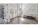 Bright foyer featuring hardwood floors, staircase, and white trim at 6448 Mobilis Ct, Sugar Hill, GA 30518