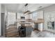 Bright kitchen with white cabinets, stainless appliances, kitchen island, and open layout at 6448 Mobilis Ct, Sugar Hill, GA 30518