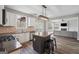 Open kitchen with stainless steel appliances, modern island, and view into the adjacent living area at 6448 Mobilis Ct, Sugar Hill, GA 30518