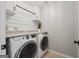 This laundry room features modern appliances, granite countertops, and shiplap accents at 6448 Mobilis Ct, Sugar Hill, GA 30518