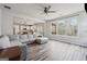 Living room opens to modern kitchen with natural light and stylish wood floors at 6448 Mobilis Ct, Sugar Hill, GA 30518