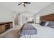 Relax in this main bedroom, complete with a sitting area, vaulted ceiling, and a ceiling fan at 6448 Mobilis Ct, Sugar Hill, GA 30518
