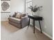 This cozy sitting area features a loveseat, sleek side table, and a view of the outdoors at 6448 Mobilis Ct, Sugar Hill, GA 30518