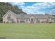Spacious lawn showcases the rear exterior and landscaping of this home at 676 Mcbride Rd, Fayetteville, GA 30215