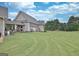 Charming single-Gathering home with a well-maintained lawn and an inviting covered porch, perfect for outdoor relaxation at 676 Mcbride Rd, Fayetteville, GA 30215