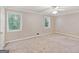 Spacious carpeted bedroom featuring a ceiling fan and ample natural light from the windows at 1099 Westfield Se Trce, Smyrna, GA 30082