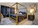 A primary bedroom featuring a four-poster bed and elegant decor at 2587 Alvecot Cir, Atlanta, GA 30339