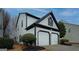 Side angle showcasing the home's two-car garage and well-maintained siding at 2587 Alvecot Cir, Atlanta, GA 30339