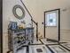 Elegant foyer with patterned tile flooring, ornate console table, and staircase at 2587 Alvecot Cir, Atlanta, GA 30339