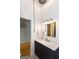 Modern bathroom vanity with a marble countertop, stylish fixtures, and a well-lit mirror at 1661 La France Street Ne Unit #216, Atlanta, GA 30307