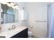 Bright bathroom featuring a modern vanity, elegant fixtures, and tiled shower with curtain at 1661 La France Street Ne Unit #216, Atlanta, GA 30307