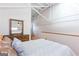 Spacious bedroom with high ceilings, exposed beams and a comfortable bed with decorative pillows at 1661 La France Street Ne Unit #216, Atlanta, GA 30307