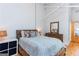 Bedroom with hardwood floors, white walls, and a comfortable-looking bed with dresser at 1661 La France Street Ne Unit #216, Atlanta, GA 30307