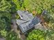 Aerial view of a home with meticulously maintained landscaping surrounded by trees and a circular driveway at 107 Calloway Xing, Peachtree City, GA 30269