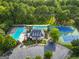 Overhead view of community amenities: clubhouse, multiple pools, tennis courts, and parking at 107 Calloway Xing, Peachtree City, GA 30269