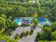 Aerial view of community clubhouse with swimming pools, tennis courts, parking, surrounded by lush greenery at 107 Calloway Xing, Peachtree City, GA 30269