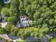 Aerial view of a home surrounded by lush trees, with a circular driveway, close to neighborhood streets at 107 Calloway Xing, Peachtree City, GA 30269