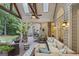 Spacious covered patio with vaulted ceilings, a ceiling fan, comfortable seating, and serene wooded views at 107 Calloway Xing, Peachtree City, GA 30269