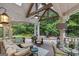Expansive covered back porch with a seating area, ceiling fan, and a view of the landscaped yard at 107 Calloway Xing, Peachtree City, GA 30269