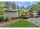 Scenic backyard featuring a rock garden, manicured lawn, and covered patio ideal for outdoor living at 107 Calloway Xing, Peachtree City, GA 30269