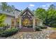 Covered backyard patio with comfortable seating, elegant design, and manicured landscaping at 107 Calloway Xing, Peachtree City, GA 30269