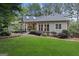 Scenic backyard with mature landscaping, manicured lawn, and foliage enhancing the home's exterior at 107 Calloway Xing, Peachtree City, GA 30269
