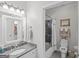 Cozy bathroom features a granite countertop vanity, a white-trimmed mirror, and an adjoining toilet and shower area at 107 Calloway Xing, Peachtree City, GA 30269