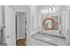 Bathroom features modern granite countertops, updated fixtures, and a decorative mirror with access to the shower at 107 Calloway Xing, Peachtree City, GA 30269