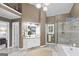 Bathroom with a vanity with granite counters, walk-in shower, and travertine-like tile flooring at 107 Calloway Xing, Peachtree City, GA 30269