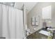 Neutral bathroom featuring a shower with a white shower curtain, toilet, and granite sink with a dark finish at 107 Calloway Xing, Peachtree City, GA 30269