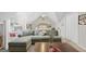 Bright, carpeted bedroom featuring a seating area, built in shelving and an abundance of natural light at 107 Calloway Xing, Peachtree City, GA 30269