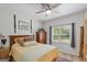 Comfortable bedroom features an inviting bed with throw pillows, a ceiling fan, and a window with plantation shutters at 107 Calloway Xing, Peachtree City, GA 30269