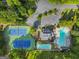 Aerial view showing tennis courts, swimming pool, clubhouse, and parking area surrounded by trees at 107 Calloway Xing, Peachtree City, GA 30269