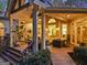 Covered patio with comfortable seating, ceiling fan, and access to a beautifully landscaped backyard at 107 Calloway Xing, Peachtree City, GA 30269