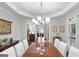 Bright dining room with tray ceiling, modern chandelier, and hardwood floors at 107 Calloway Xing, Peachtree City, GA 30269