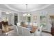 Elegant dining room with tray ceiling, white chairs, and wood table at 107 Calloway Xing, Peachtree City, GA 30269