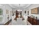 Stylish dining room with a tray ceiling, a wood table, and french doors at 107 Calloway Xing, Peachtree City, GA 30269