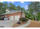 Brick home with a three-car garage, landscaped front yard, and a charming walkway to the entrance at 107 Calloway Xing, Peachtree City, GA 30269