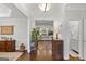 Bright foyer features hardwood floors, a large plant, and an open view into the living room and bathroom at 107 Calloway Xing, Peachtree City, GA 30269