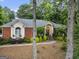 Charming single-story brick home with well-manicured landscaping, arched windows, and an inviting entrance at 107 Calloway Xing, Peachtree City, GA 30269