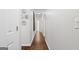 Clean hallway with hardwood floors, leading to various rooms, featuring decorative plates and light-colored walls at 107 Calloway Xing, Peachtree City, GA 30269