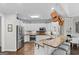 Charming kitchen with white cabinets, granite countertops, stainless steel appliances, and a breakfast bar at 107 Calloway Xing, Peachtree City, GA 30269