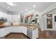 Beautiful kitchen featuring white cabinets, granite countertops, stainless steel appliances, and a hanging pot rack at 107 Calloway Xing, Peachtree City, GA 30269