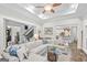 Open-concept living room with a white sectional, access to stairs, and a view into the kitchen at 107 Calloway Xing, Peachtree City, GA 30269